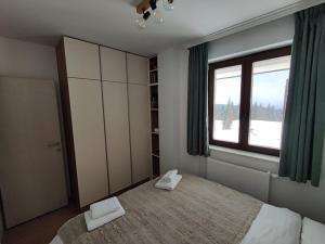 a bedroom with a large bed and a window at Vila Akva in Jahorina