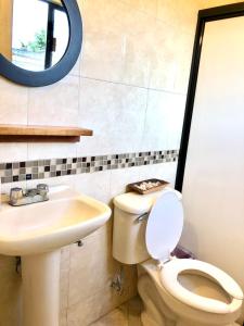 a bathroom with a toilet and a sink at Casa Gecko in Oaxaca City