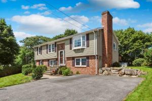 a house with a brick chimney and a driveway at Ocean Breeze-8min Walk to Beach in Gloucester