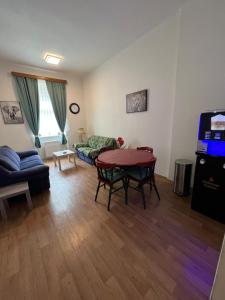 a living room with a table and a couch at Hostel Jasmin in Prague