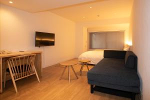 高知市にある高知サンライズホテルのベッドルーム(ベッド1台、椅子、テレビ付)