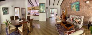 a living room with a table and a dining room at Botanica House Kuranda in Kuranda