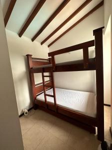 two bunk beds in a room with a ceiling at Apartasol Santafe de Antioquia 15 in Santa Fe de Antioquia