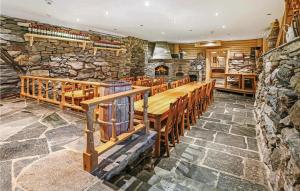 um quarto amplo com uma parede de pedra e uma longa mesa de madeira em 10 Bedroom Amazing Home In len em Vaka