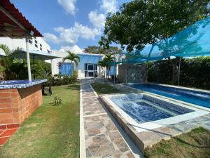 a swimming pool in the backyard of a house at Casa campestre, Ricaurte Cundinamarca in Ricaurte