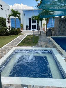 a swimming pool in front of a house at Casa campestre, Ricaurte Cundinamarca in Ricaurte