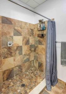 a bathroom with a shower with a tiled shower at Modern Loft Style on Monroe by Dwtn & Park ave in Rochester