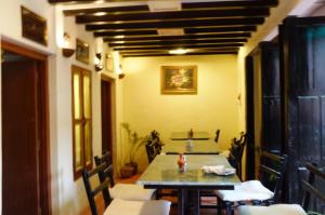 a dining room with a table and chairs at Tulaja Boutique Hotel in Bhaktapur