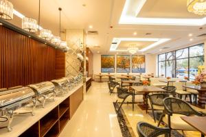 a dining room with tables and chairs in a restaurant at MT Collection Hotel in Ninh Binh