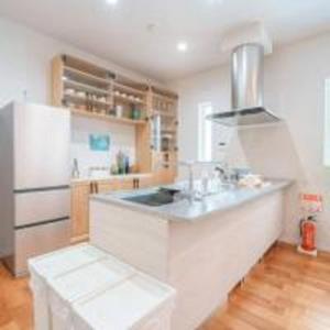 a kitchen with a white counter and a refrigerator at Beachside base KURUWA in Yokosuka