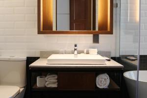 a bathroom with a sink and a toilet at WEIL Hotel Ipoh in Ipoh