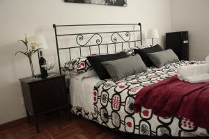 a bedroom with a bed with a black and white comforter at St. John Villa in Rome