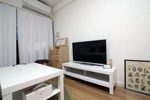 a living room with a television on a white table at GM Shinjuku in Tokyo