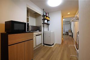 a kitchen with a tv on a counter in a room at GM Shinjuku in Tokyo