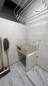 ein Bad mit einem Waschbecken in der Ecke eines Zimmers in der Unterkunft Comodo Apartamento Cartago Valle in Cartago