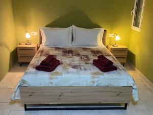 a bedroom with a large bed with two night stands at CASA JOHN in Alepou