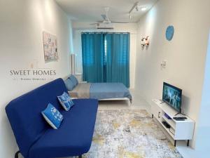 a living room with a blue couch and a bed at Blue Studio Suite 1-4pax B'Worth Prai@SwimmingPool in Perai