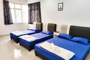 3 camas en una habitación con sábanas azules en Equine Park Landed H.stay-Farm in the City-12Pax, en Seri Kembangan