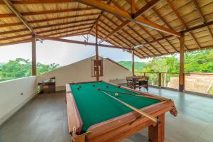 a pool table in a room with a roof at Riosol Hotel Laguna Azul in Sauce