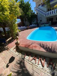 a swimming pool in a yard next to a house at El mana de San Francisco in Oaxaca City