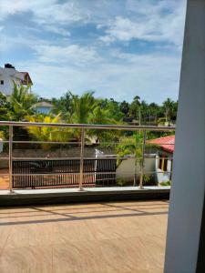 a balcony with a view of a river and palm trees at Hotel Sun Blue in Trincomalee +25 photos