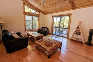 a living room with a couch and a table at Bel Air of Big Bear - Fun & Tech & Massive Cabin in Big Bear City +66 photos