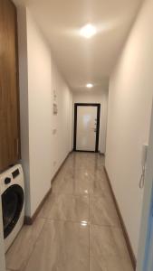 a hallway with a washing machine and a door at Girnenin kalbinde tatil in Kérynia