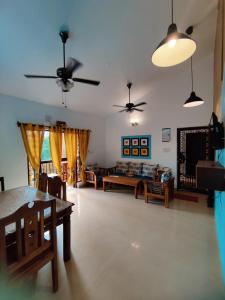 a living room with a couch and a table at Ronne's 2BHK Lagoon Apartment -Calangute in Calangute