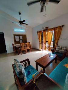 a living room with a couch and a table at Ronne's 2BHK Lagoon Apartment -Calangute in Calangute