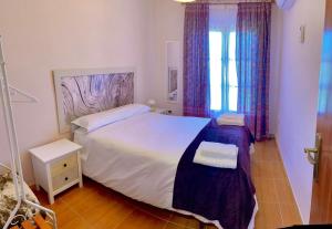 Un dormitorio con una cama grande y una ventana en CASA BRIGIDA en Jerte