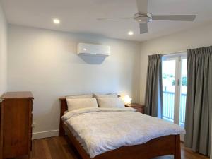 a bedroom with a bed and a window at Fully Renovated 3 Bedroom House in Belmont