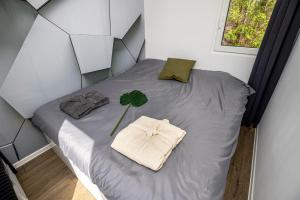 a bed with two towels and a plant on it at no. 1 in Kulpin