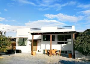 a white house with awning on the side of it at Villa Sevasti in Kardamaina