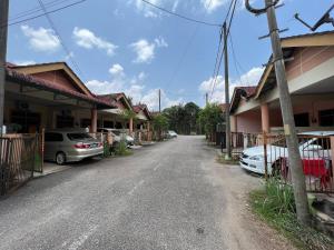 an empty street with cars parked next to houses at 7 STAY at Kuala Berang -Free WiFi & Netflix for 3 Pax in Kuala Berang
