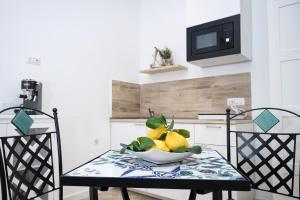 a bowl of fruit on a table in a kitchen at B&B DieMme Amalfi Coast in Vietri sul Mare