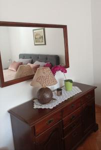 a table with a lamp and a mirror on a bed at Lina at the best in Krk