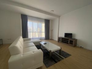 a living room with a white couch and a coffee table at Al Mashreq 2 BR Rimal 1, City View - JBR in Dubai