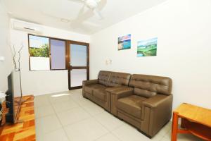 a living room with a couch and a table at Gardenia Apartment-02 in Nadi