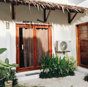 a house with a wooden door and a window at Casa De Loren in General Luna