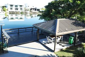 a deck with a gazebo next to the water at Gardenia Apartment-02 in Nadi