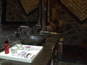 a bathroom counter with a sink and a bowl at Valhalla Bed & Breakfast in Salatiga