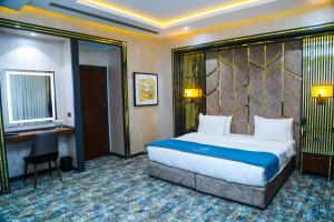 a hotel room with a bed and a desk at Iris Hotel Baku - Halal Hotel in Baku