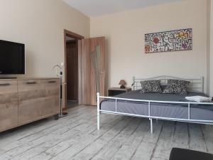 a bedroom with a bed and a flat screen tv at Lefterov's Guests Suite in Varna City