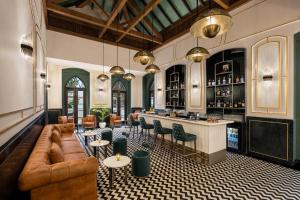 a living room with a couch and a bar at The Yellow House, Goa - IHCL SeleQtions in Anjuna