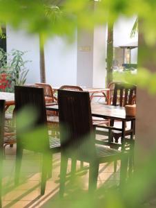 a table and chairs and a table and a table and chairs at BLANK GUEST HOUSE in Siem Reap