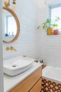 a bathroom with a white sink and a mirror at Tel Aviv Center Seaside Villa with a Pool & Rooftop in Tel Aviv