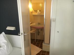 a bathroom with a sink and a toilet and a mirror at City Hostel by beans parc in Wilhelmshaven