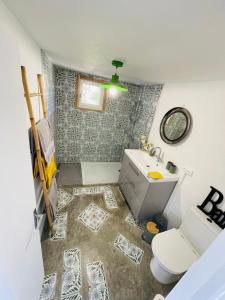 a small bathroom with a toilet and a sink at Le Planzollais in Planzolles