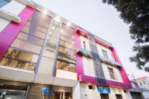 a building with a colorful facade on a street at Collection O Sapphire in Manī Mājra