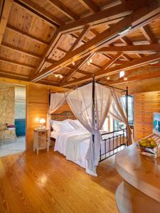 a bedroom with a bed with a mosquito net at Ariadne - Apokoron Villa with 2 Large Private Pools and Great Views in Gavalochori